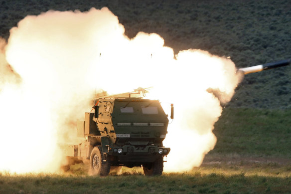 Un camion de lancement tire le lanceur de missiles à longue portée HIMARS.