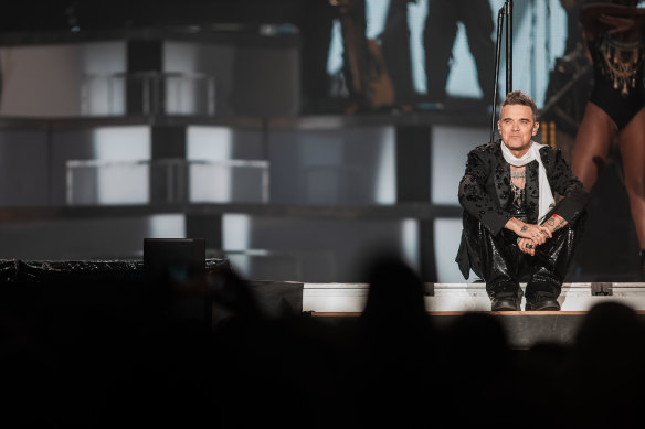 Williams passe autant de temps à raconter des anecdotes et à parler à la foule qu'à chanter.