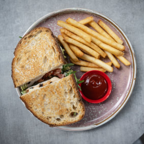 Le sandwich au poulet grillé avec des frites au Concrete Jungle Cafe. 