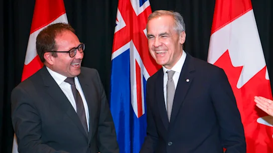 Le Premier ministre canadien Mark Carney, au centre, avec le trésorier adjoint Daniel Mulino,