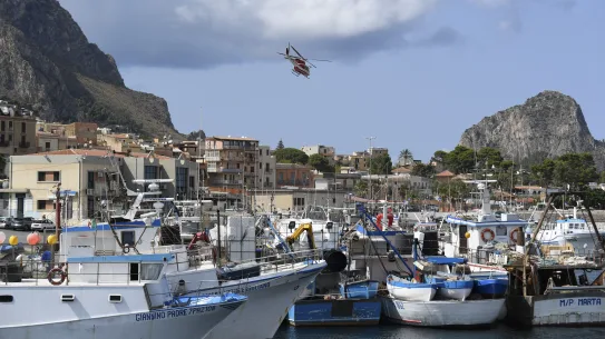Un hélicoptère des pompiers italiens survole le port de Porticello, dans le sud de l'Italie.